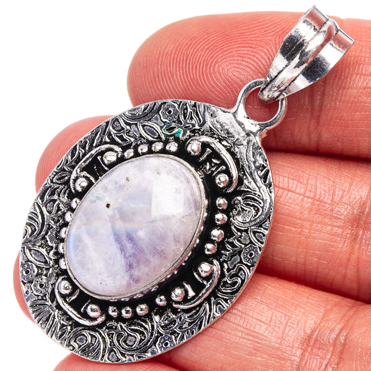 German silver oval moonstone pendant with ornate bezel and rainbow cabochon