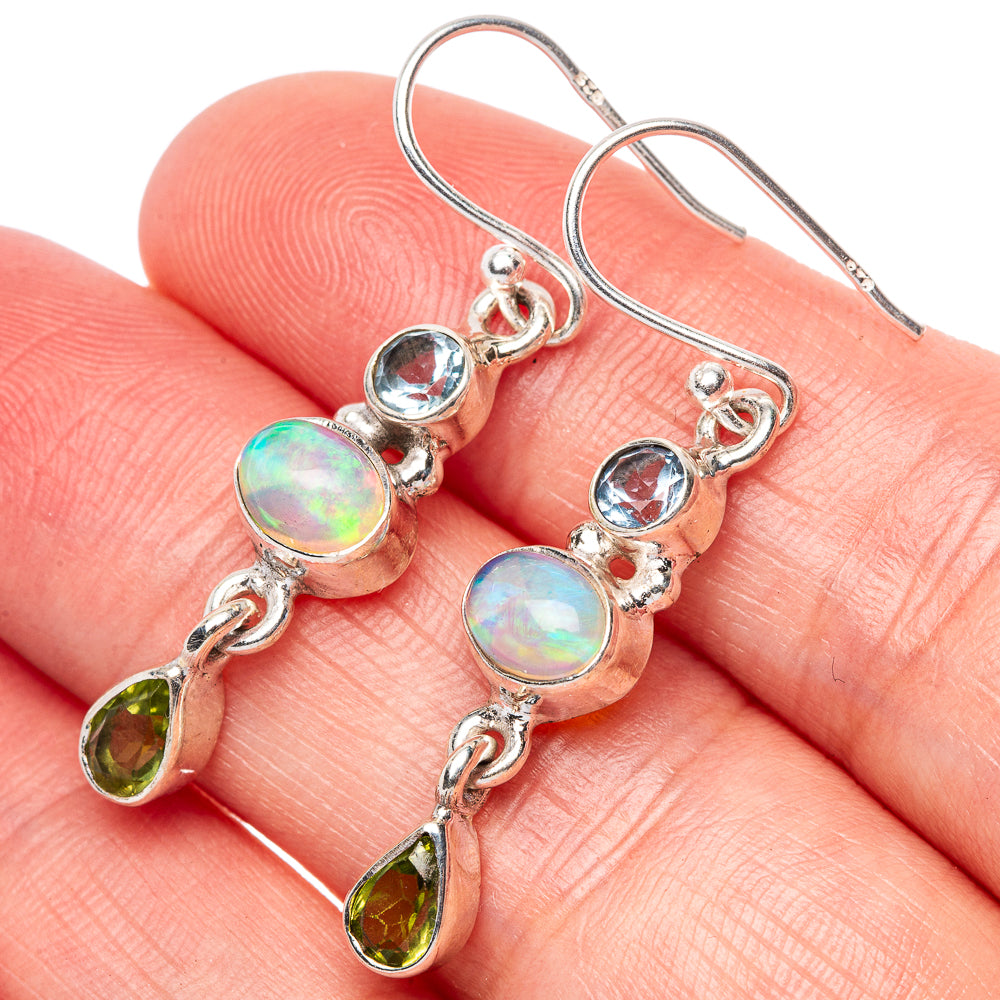Sterling silver drop earrings with blue topaz, opal, and peridot teardrops