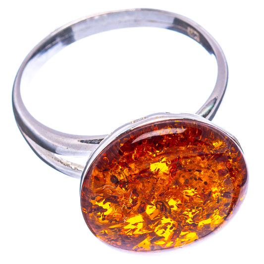 Round orange Baltic amber cabochon set in .925 sterling silver adjustable ring