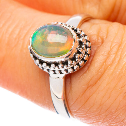 Sterling silver opal cabochon ring with oval green multicolor stone and beaded halo