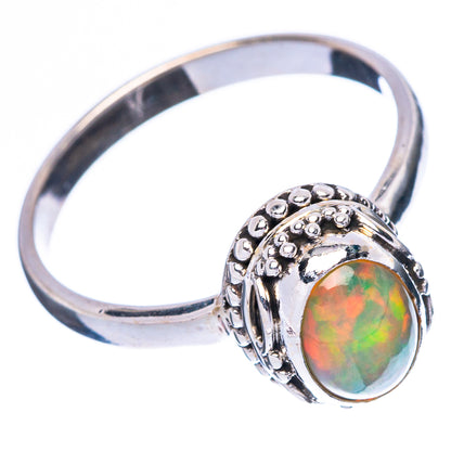 Sterling silver opal ring with round-oval gemstone, ornate top bezel and band