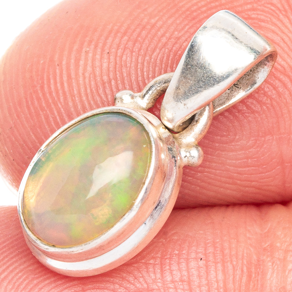 Oval opal pendant in sterling silver bezel setting with top bail loop