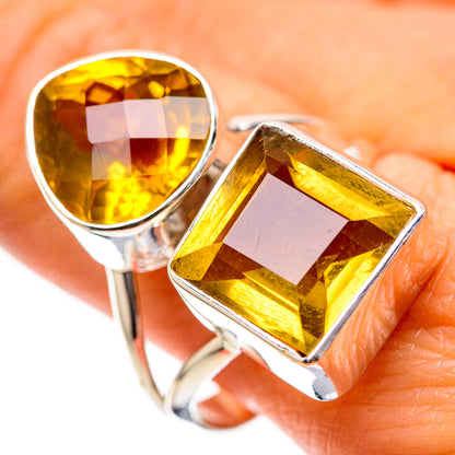 Sterling silver ring with round and cushion-cut citrine stones, faceted bezel settings