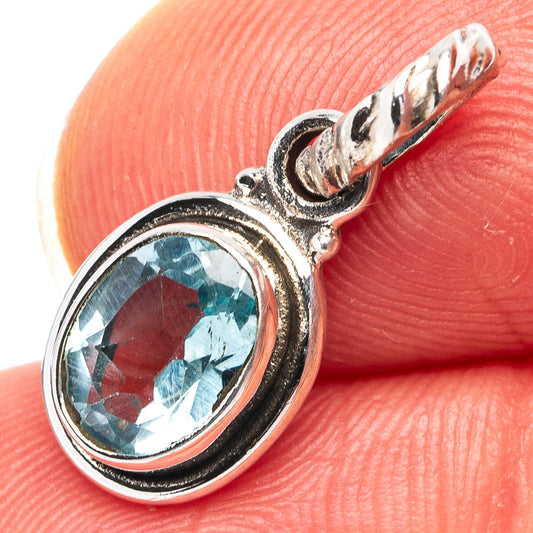 Oval blue topaz pendant with .925 sterling silver prong setting and loop bail