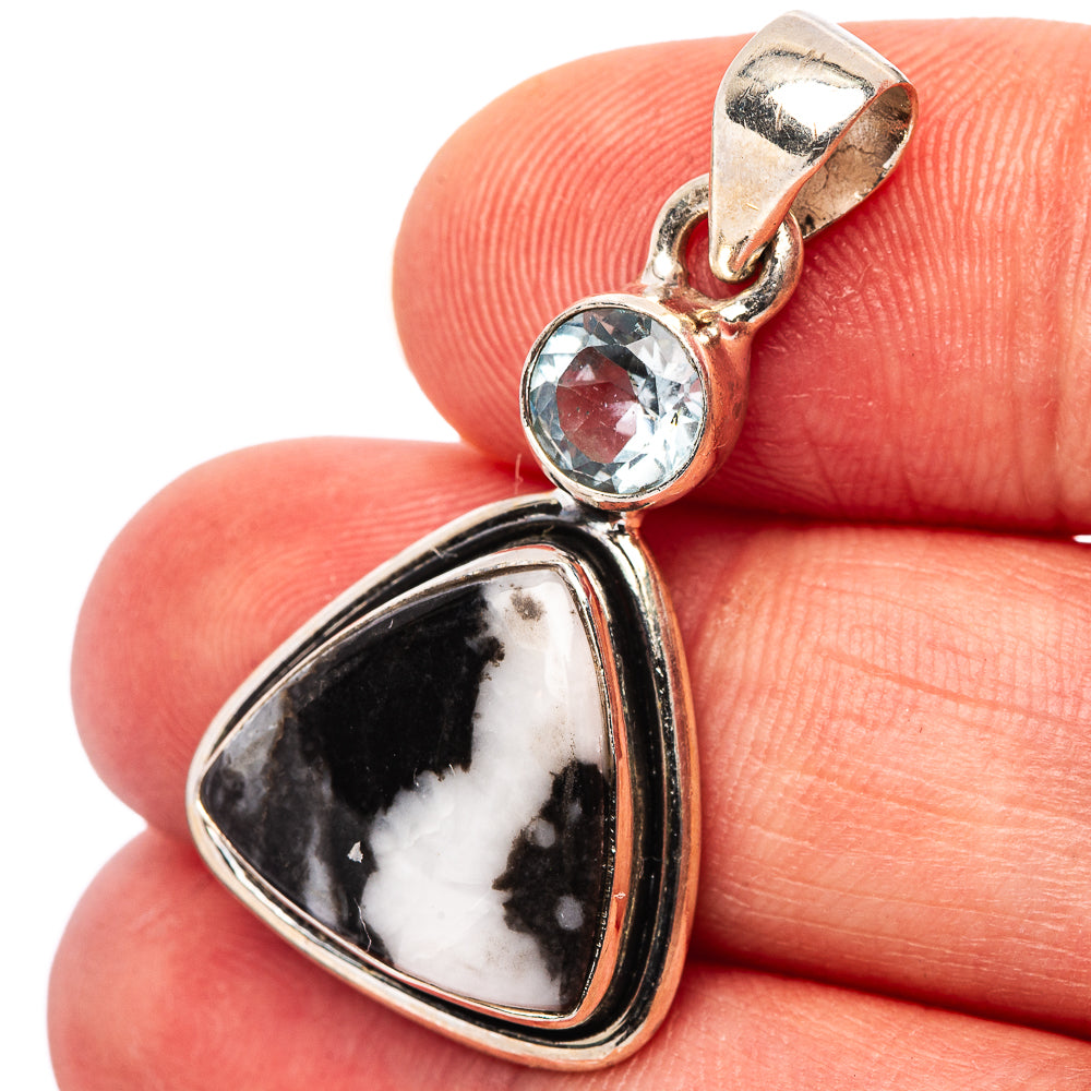 Sterling silver pendant with round blue gemstone and pear-shaped buffalo stone detail