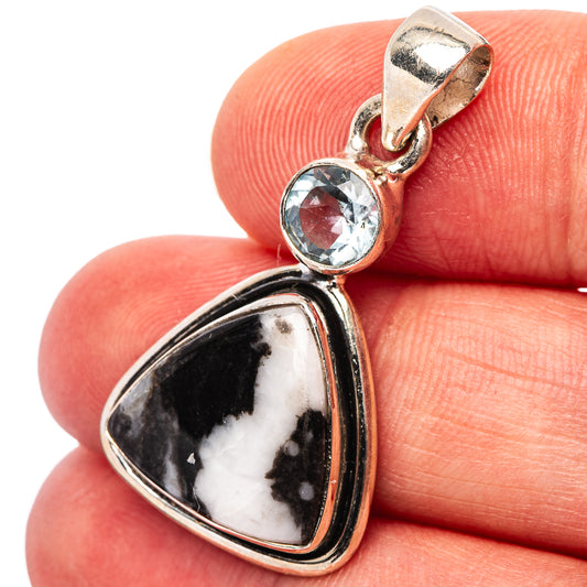 Sterling silver pendant with round blue gemstone and pear-shaped buffalo stone detail