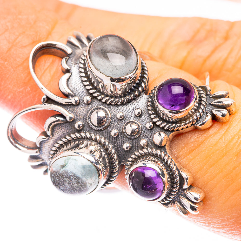 Sterling silver ring with large clear aquamarine cabochon and three purple amethyst stones