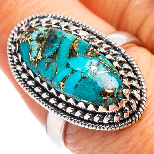 Sterling silver turquoise ring with oval cabochon and braided bezel, gold flecks.