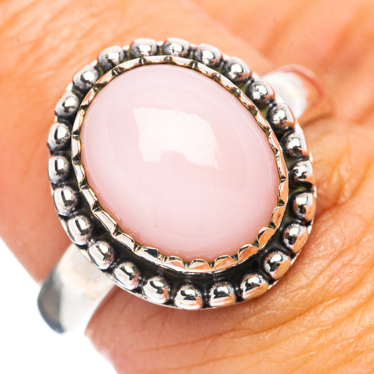 Sterling silver ring with oval pink cabochon opal and beaded halo bezel