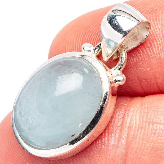 Aquamarine pendant in oval sterling silver bezel with small bail, light blue stone.