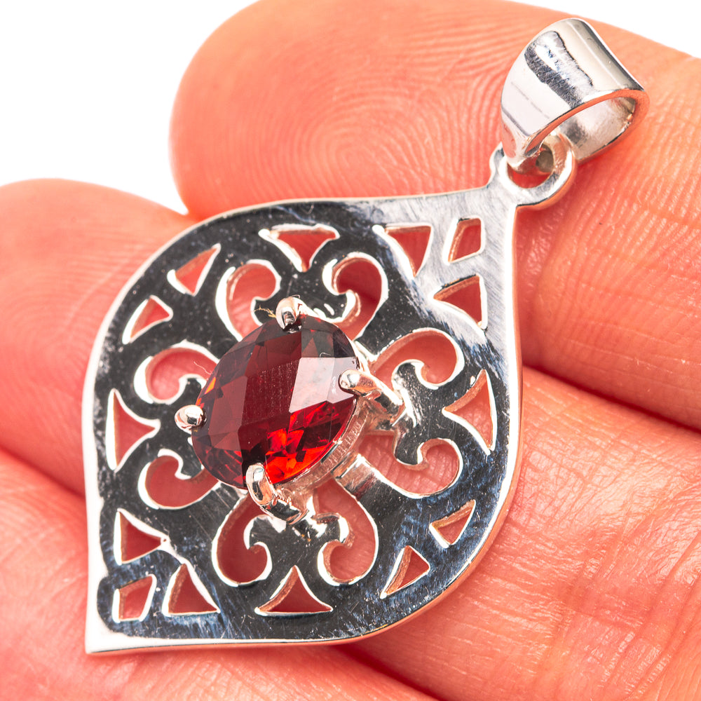 Heart-shaped 925 sterling silver pendant with dark red garnet and ornate filigree border