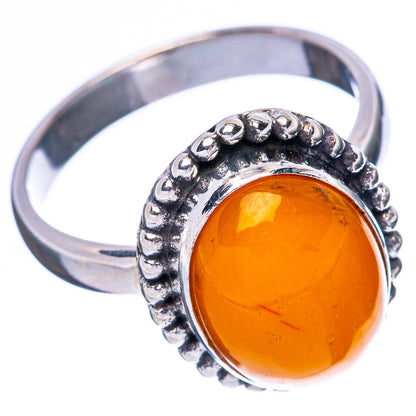 Sterling silver ring with oval amber cabochon, textured bezel, side view