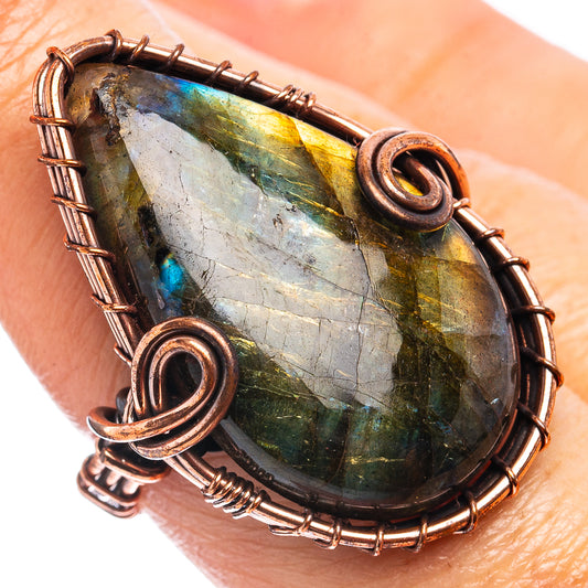 Oxidized copper wire-wrap ring with oval labradorite gemstone, spiral bezel detail