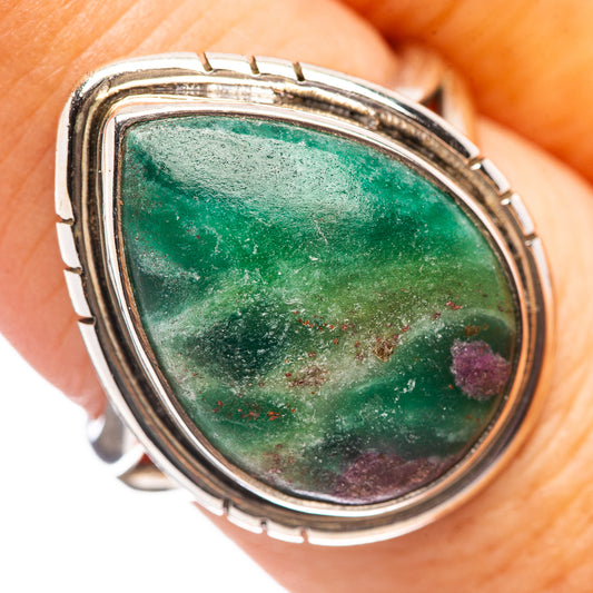 Oval green gemstone sterling silver ring with textured bezel, close-up detail