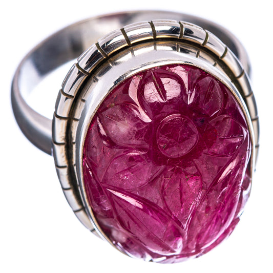 Carved ruby ring with silver band and oval setting, bright magenta-red gemstone