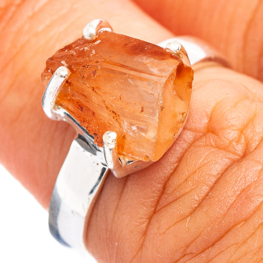 Orange aragonite ring top view: faceted orange gemstone in silver prong setting