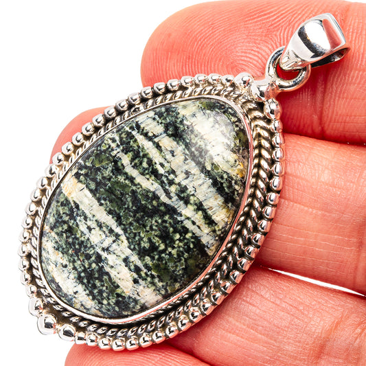Sterling silver oval opal pendant with green speckled cabochon and scalloped bezel