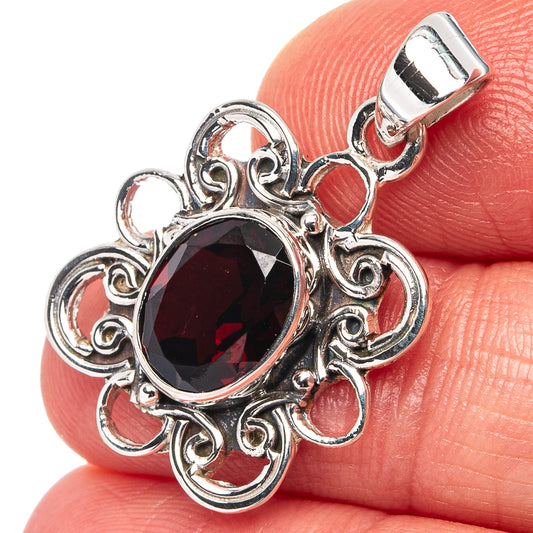 Garnet pendant in .925 sterling silver with oval red gemstone and ornate filigree frame