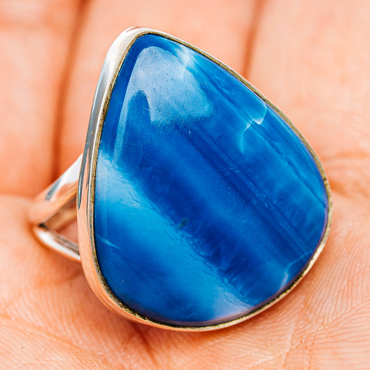 Sterling silver opal ring with blue teardrop cabochon, raised bezel, side view