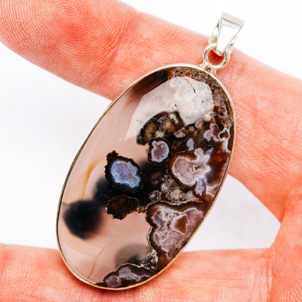 Sterling silver flower agate teardrop pendant with dark flower-like inclusions