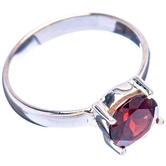 Sterling silver garnet ring with faceted dark red gemstone and sculpted prongs, size 8.25