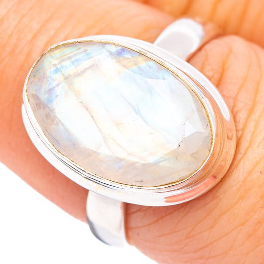 Sterling silver oval moonstone ring with pear-shaped rainbow sheen bezel