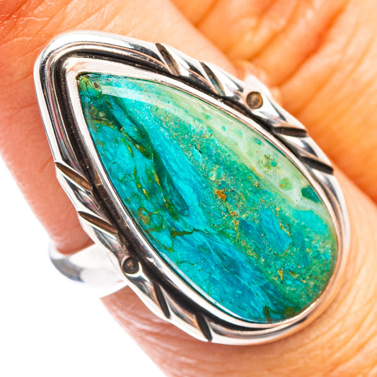Sterling silver oval opal ring with green-blue stone, decorative bezel and side studs
