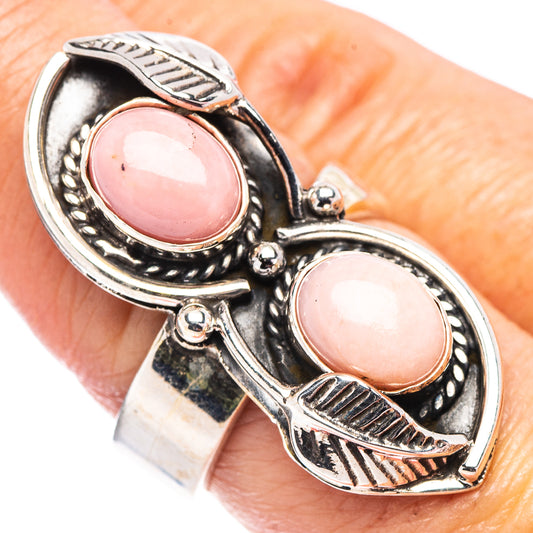 Adjustable sterling silver ring with two oval pink opal cabochons and carved metal details