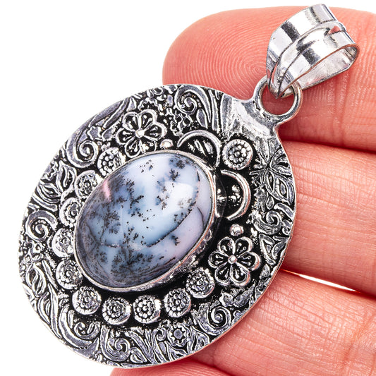 German silver dendritic opal pendant, oval stone with ornate floral filigree bezel
