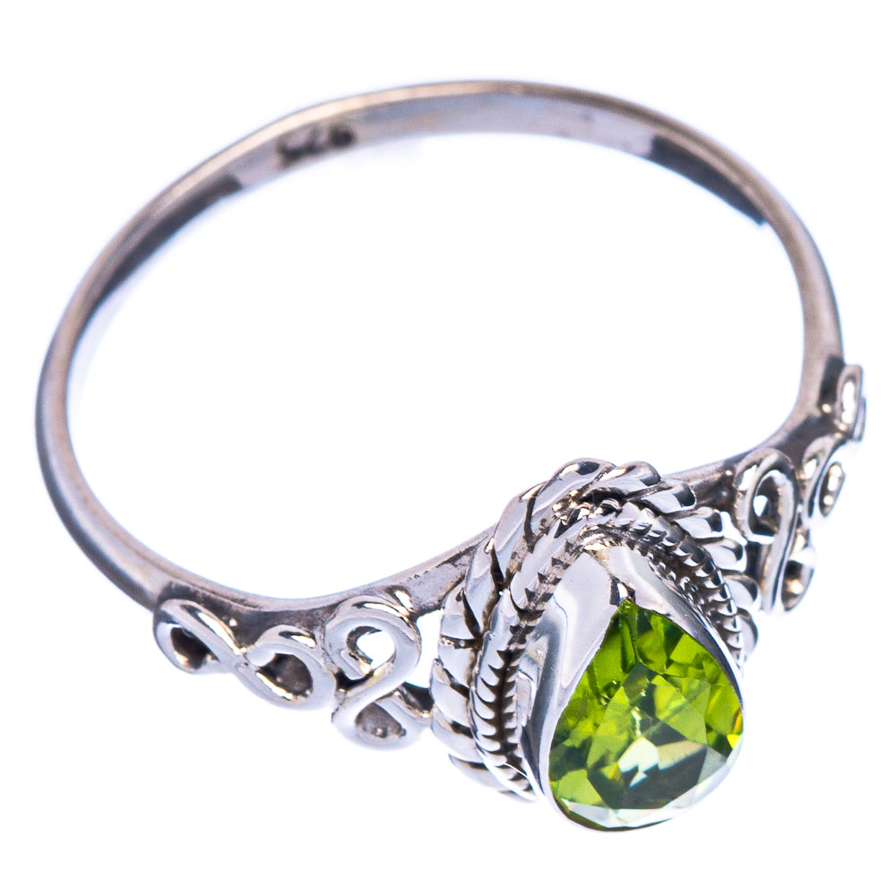 Sterling silver peridot ring with oval green gemstone and cutout scrollwork setting
