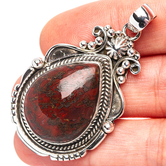 Sterling silver teardrop pendant with red mottled stone and ornate beaded bezel