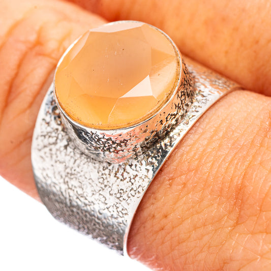 Sterling silver moonstone ring with peach oval cabochon and hammered texture, size 9