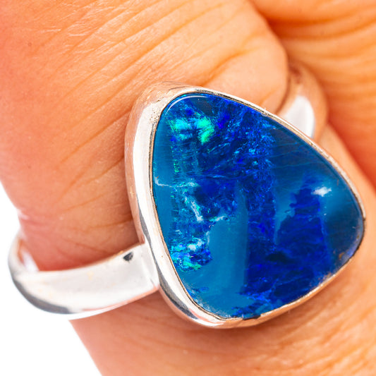 Sterling silver opal ring with oval blue gemstone in raised bezel