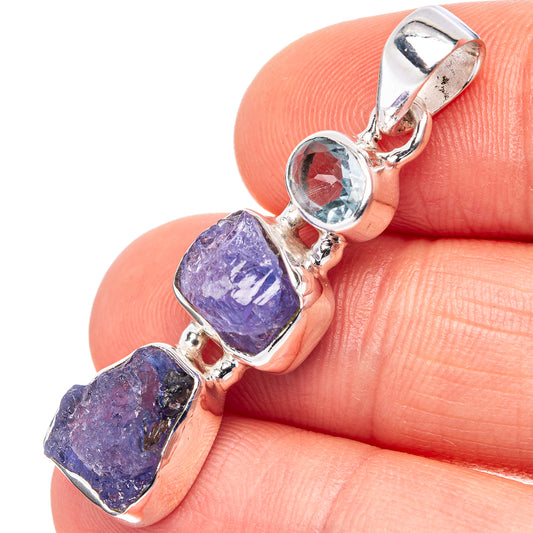 Sterling silver pendant with two rough purple tanzanite stones and blue topaz oval