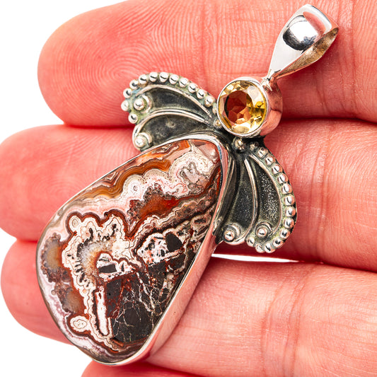 Heart-shaped crazy lace agate pendant in .925 sterling silver with yellow citrine top