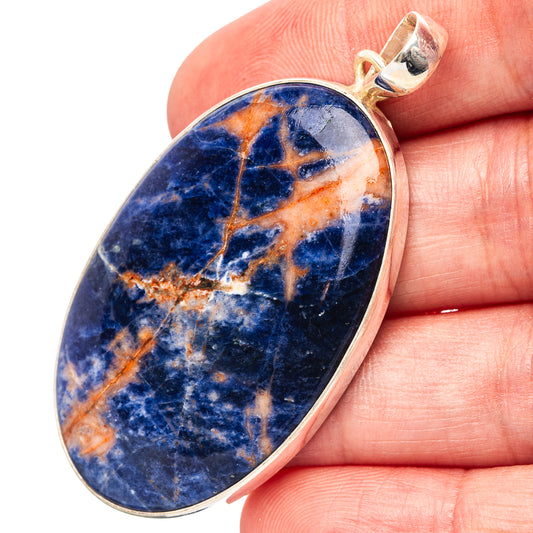 Sodalite gemstone pendant with blue stone, orange veining, and 925 silver bail