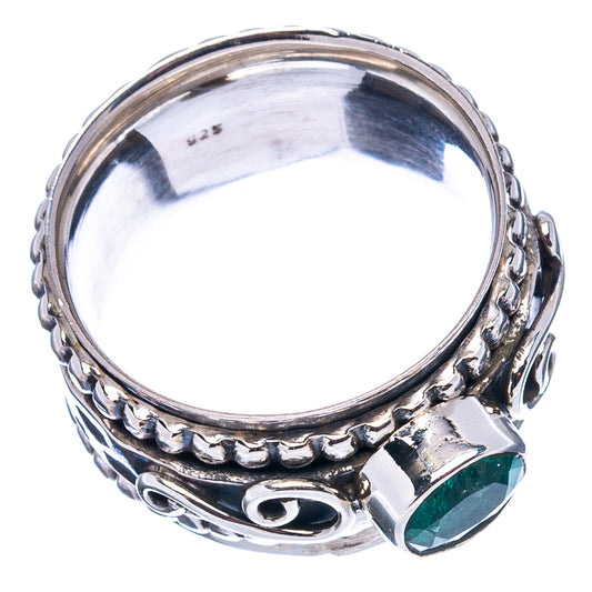 Sterling silver ring with reflective band and green gemstone bezel on the front