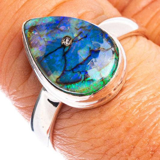 Sterling silver opal ring with oval blue-green stone in bezel setting