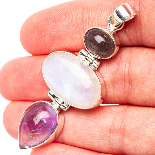 Sterling silver pendant with oval gemstones: iridescent white, purple, and dark stone