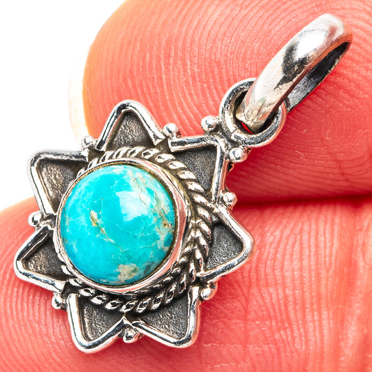 Turquoise oval pendant with ornate silver star setting and small bail clasp
