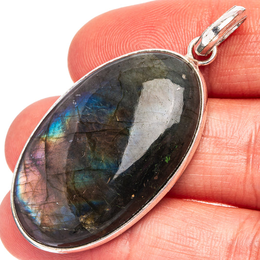 Silver-plated labradorite pendant with oval dark stone and rainbow flashes, bail loop