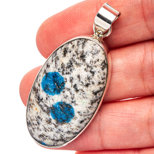 Sterling silver pendant with oval blue azurite in speckled white stone, top bail