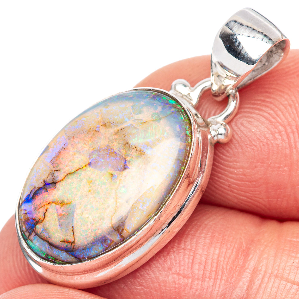 Oval sterling silver opal pendant with iridescent colorful stone and loop bail