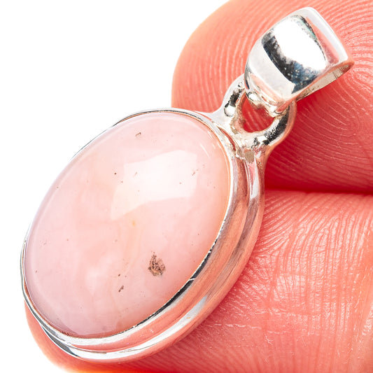 Oval pink opal cabochon pendant in polished .925 sterling silver bezel setting