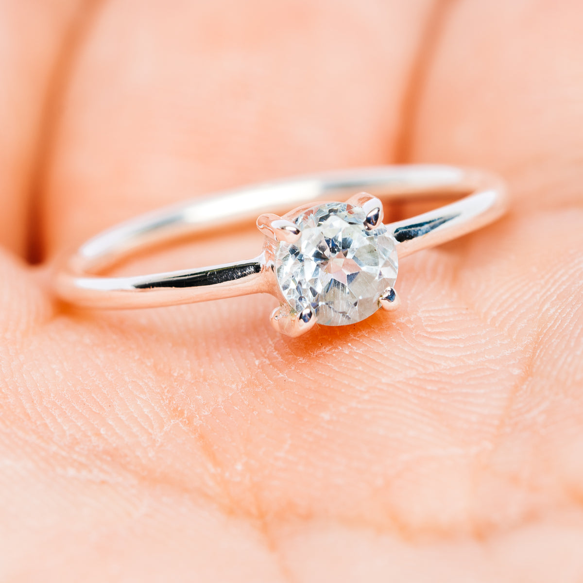 Sterling silver stackable ring set with light blue round center stone and thin bands