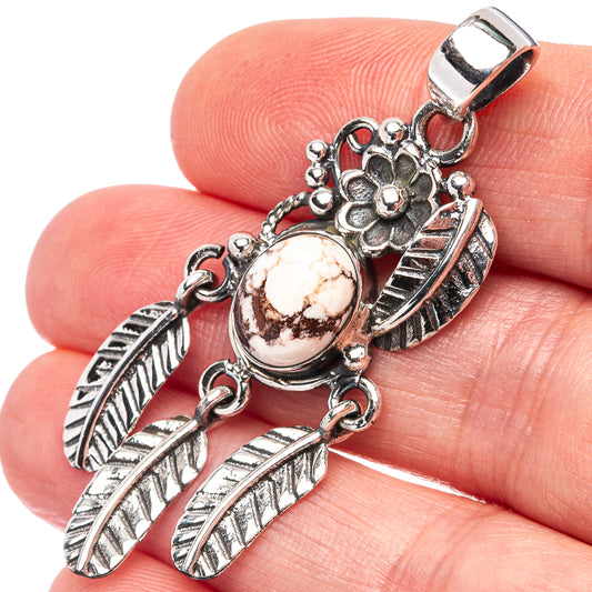 Sterling silver pendant with round earth-tone jasper cabochon and feathered drop charm