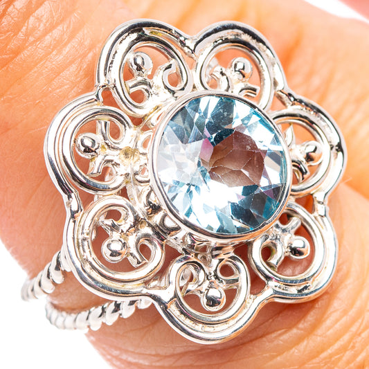 Ornate sterling silver ring with oval light-blue gemstone center