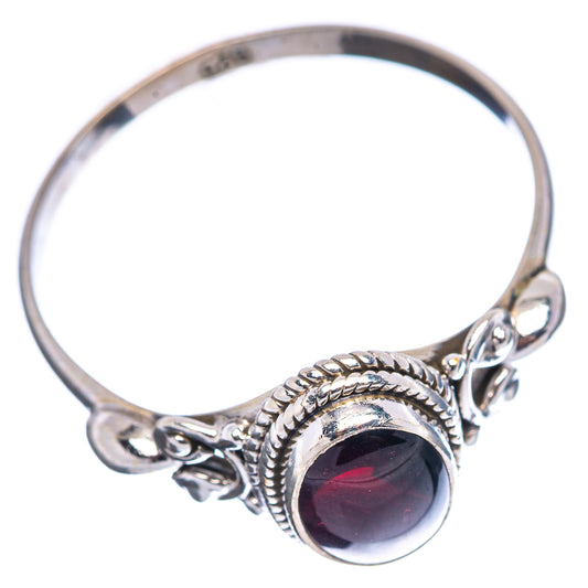 Sterling silver open ring with oval dark red gemstone, rope bezel, and linked side details