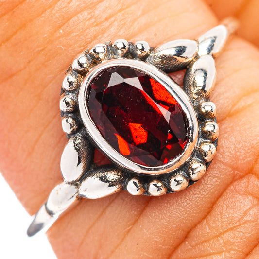 Sterling silver garnet oval ring with dark red faceted gemstone and bead halo setting