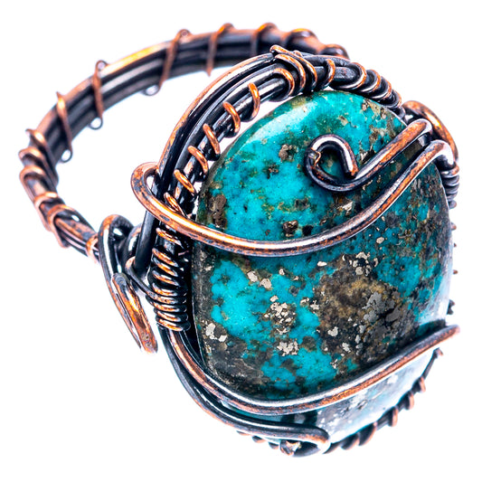 Turquoise wire wrap ring showing side prongs and oxidized copper swirl frame